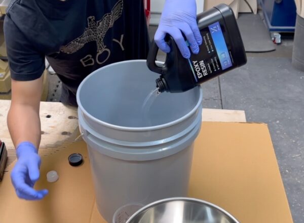 pouring deep pour epoxy resin into a mixing can