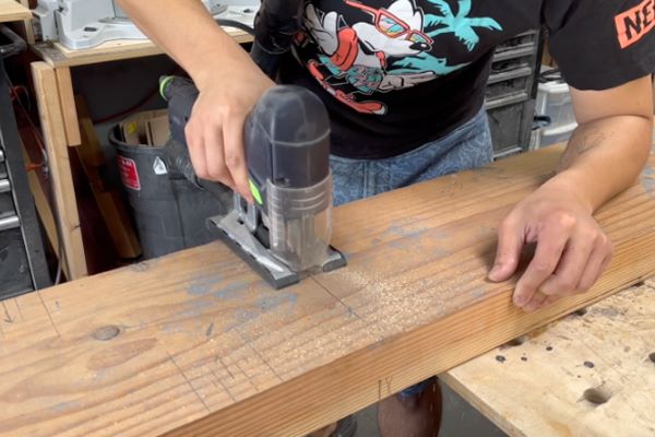 Cutting the lumber with jigsaw