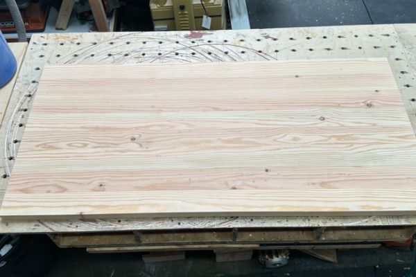 sanding 20-foot construction lumber into rough lengths for making table